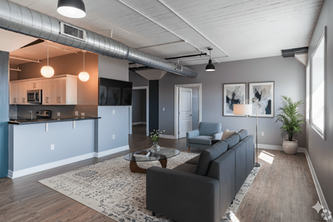 A modern living room with a grey couch and a coffee table.