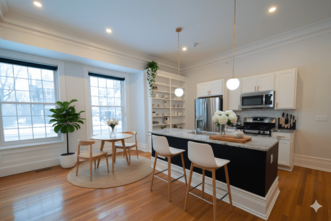 A kitchen with a table and chairs in the middle of the room.
