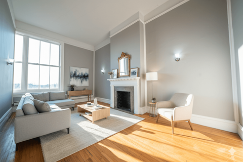 A living room with a fireplace and a chair.