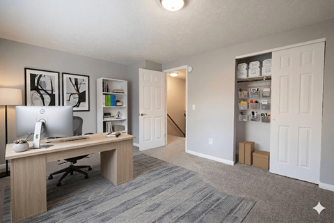A room with a desk and a computer on it.