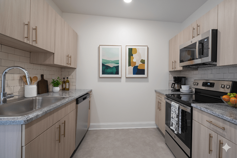 A kitchen with a black stove top oven and a sink.
