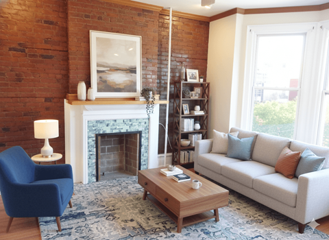 A living room with a blue chair, a white couch, and a fireplace.