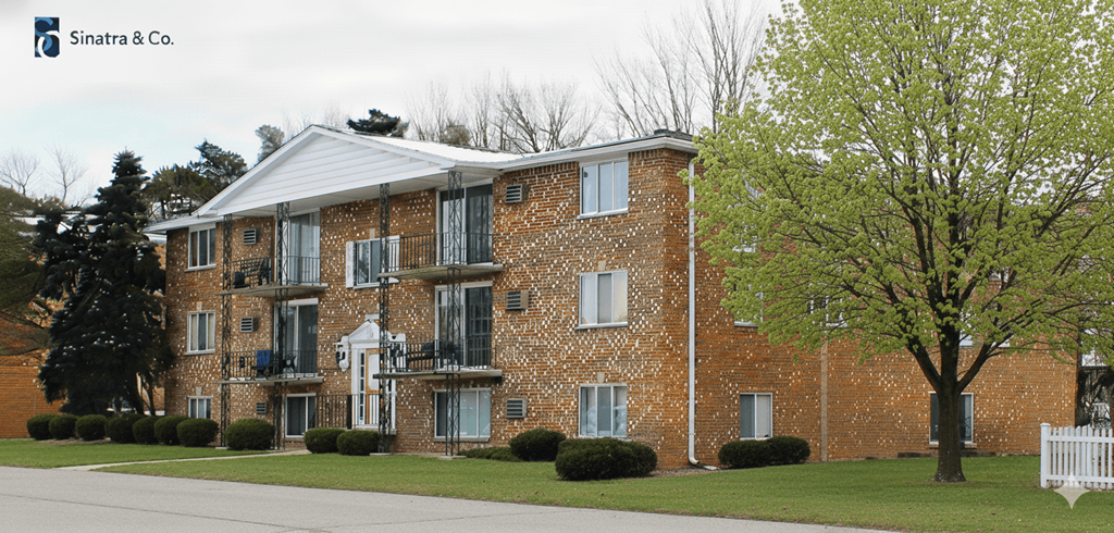 A brick building with a white picket fence in front.