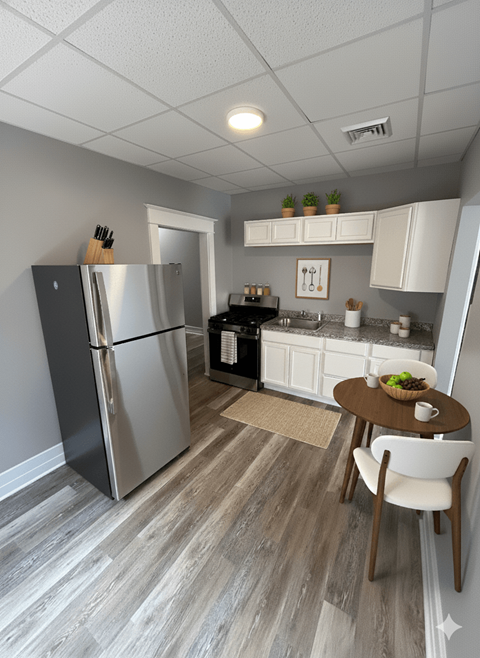A kitchen with a refrigerator, stove, and table.