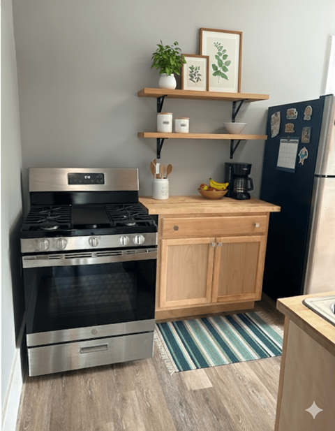 A kitchen with a stove, refrigerator, and wooden shelf.