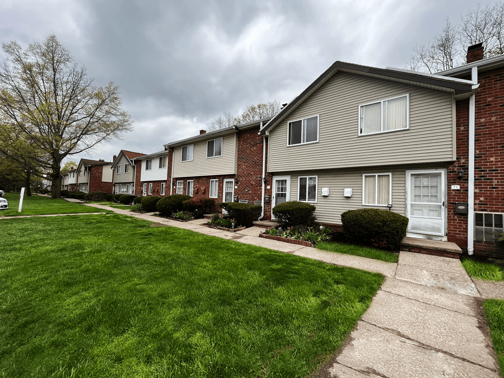 a row of houses on a cloudy day at Highview Manor Apartments, Fairport, NY, 14450