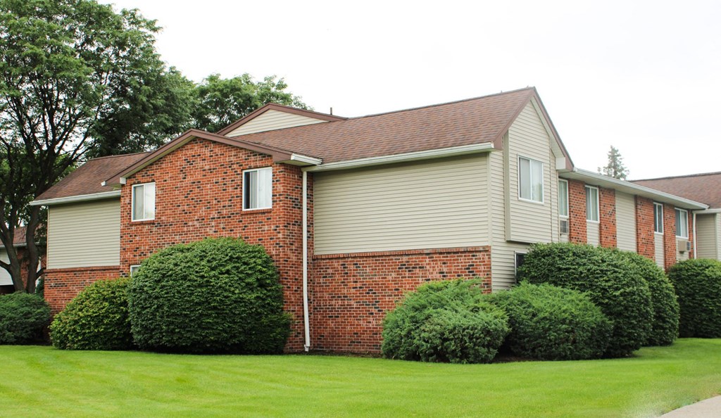 a house with a green lawn in front of it at Highview Manor Apartments, Fairport