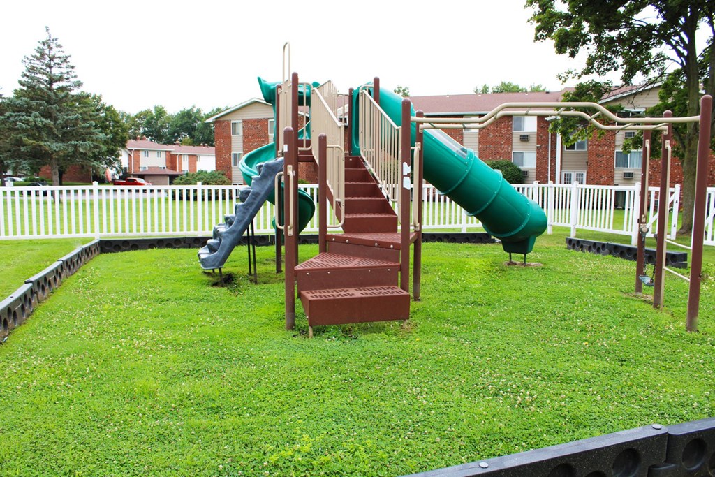 a playground with a slide and climbing equipment  at Highview Manor Apartments, Fairport, 14450