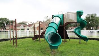 a playground with a large green slide