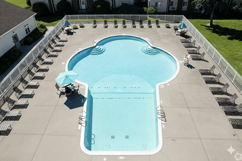 A large outdoor swimming pool surrounded by lounge chairs.at Highview Manor Apartments, Fairport, 14450