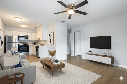 A modern living room with a grey couch, a wooden coffee table, and a flat screen TV.