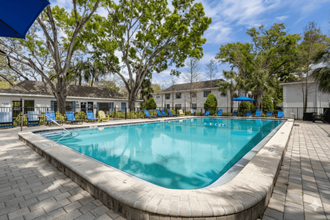 A rectangular pool with a curved edge and a brick border.