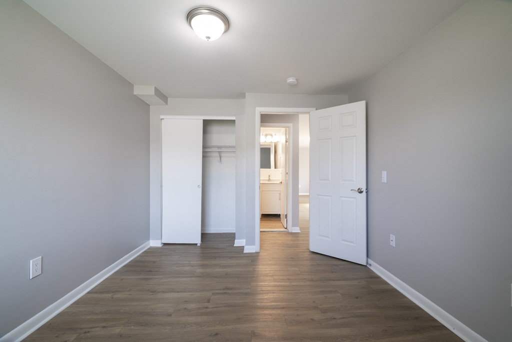 unfurnished bedroom with wooden flooring at Willowbrooke Apartments & Townhomes at 396 Willowbrooke Drive in Brockport, NY 14420