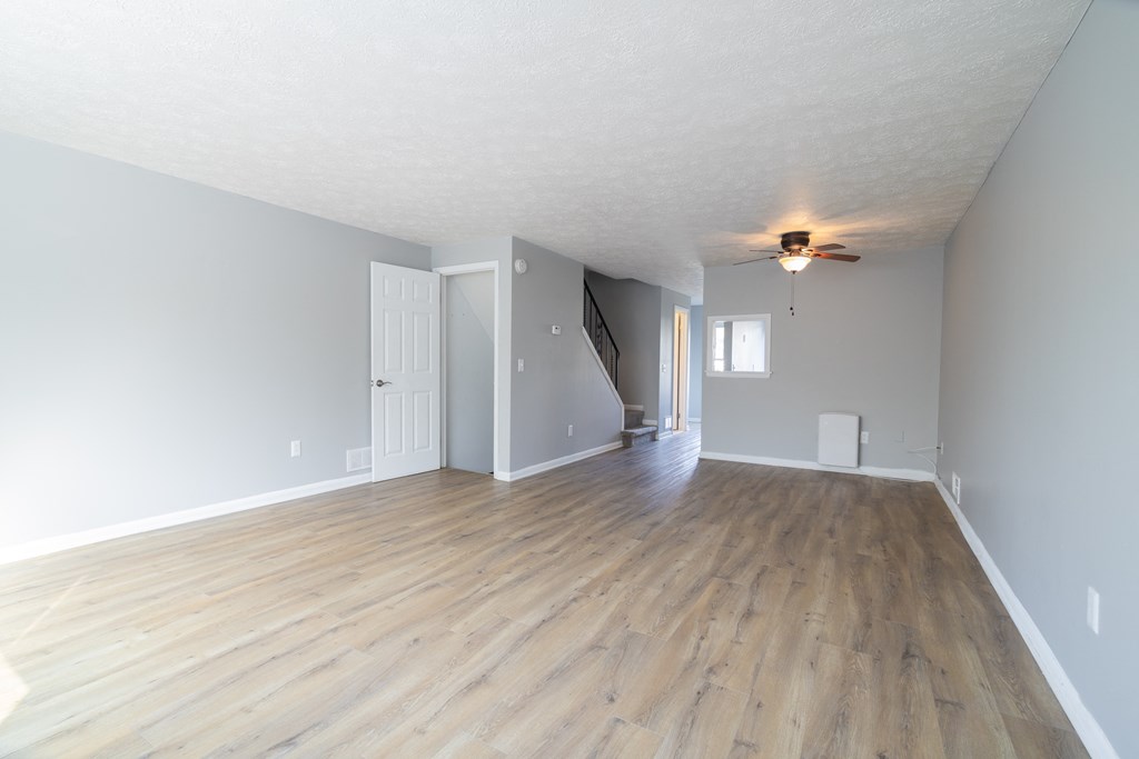Renovated Living Room with wooden flooring  at Willowbrooke Apartments & Townhomes at 396 Willowbrooke Drive in Brockport, NY 14420