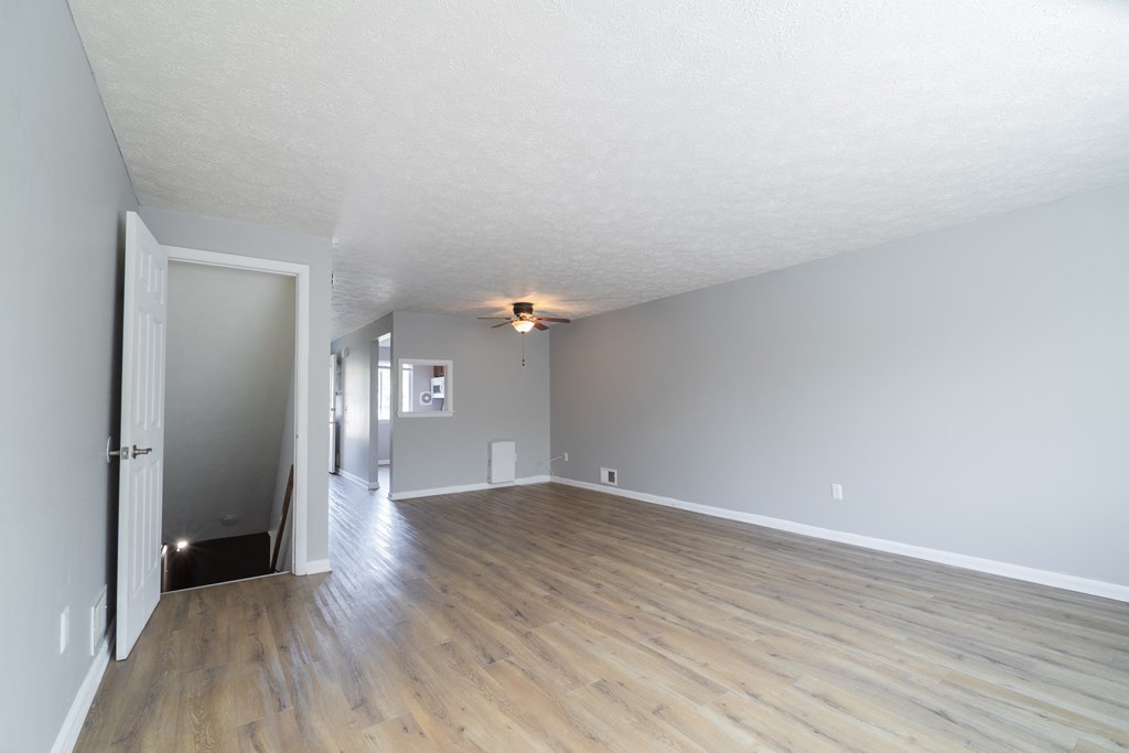 Renovated Living Room with wooden floor at Willowbrooke Apartments & Townhomes at 396 Willowbrooke Drive in Brockport, NY 14420