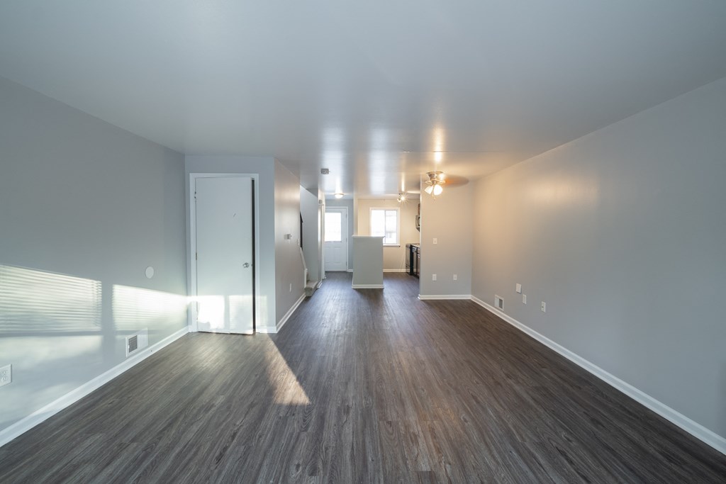 a living room and dining room with wood floors and white walls at Willowbrooke Apartments, New York