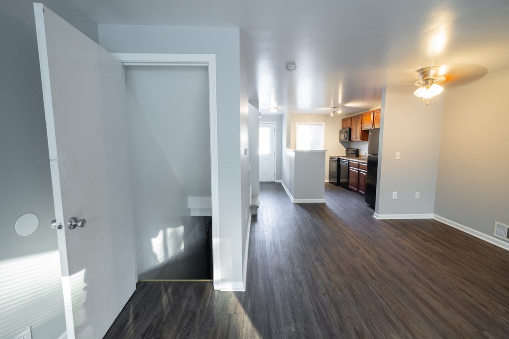 a view of a living room and kitchen from the doorway of an empty apartment at Willowbrooke Apartments, Brockport