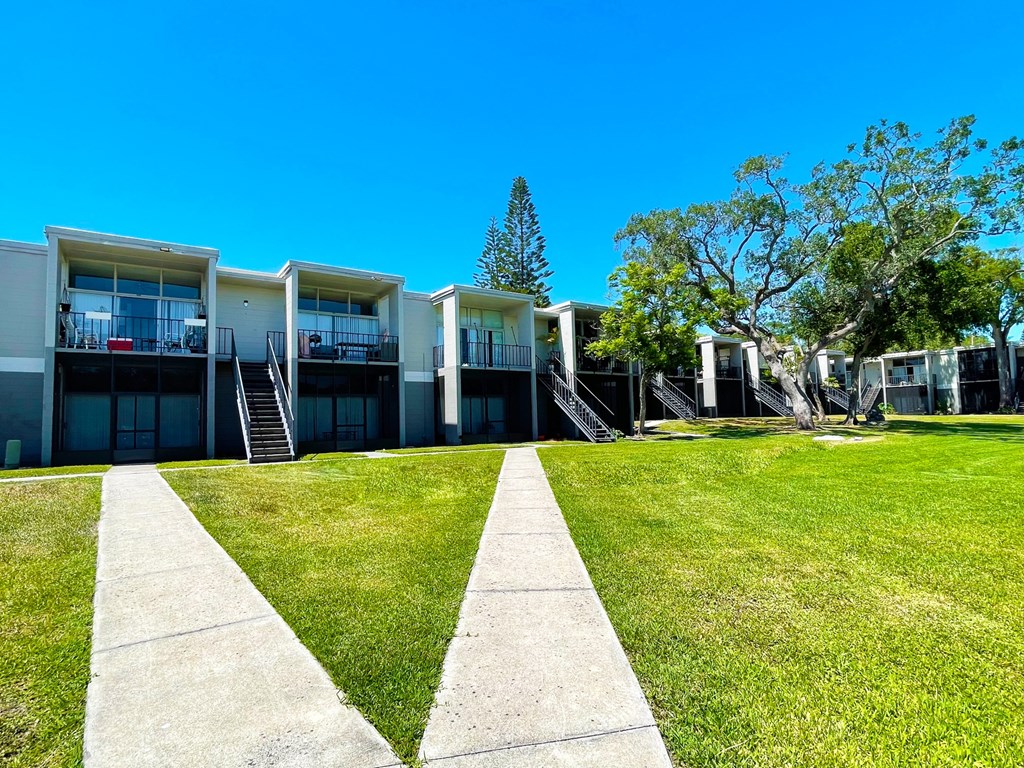 a row of houses with a grassy yard in front of them