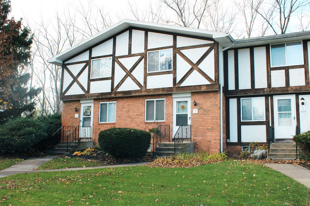 the front of a brick house with white and brown trim at Willowbrooke Apartments, Brockport, NY
