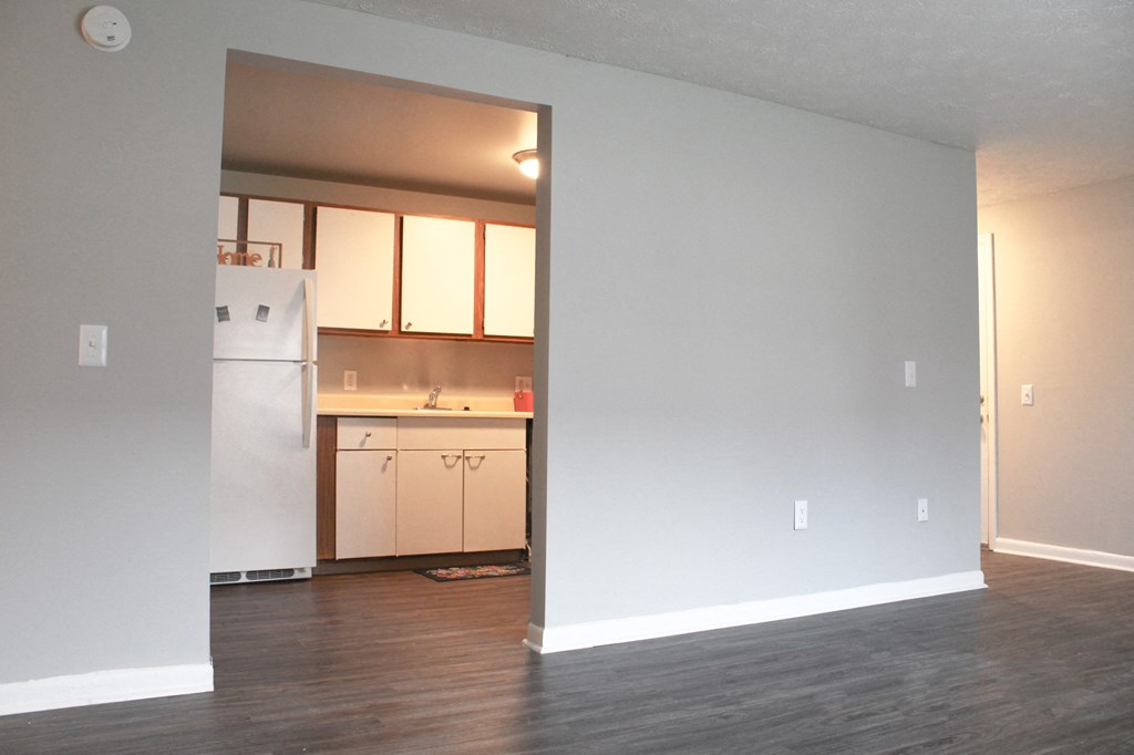 an empty living room with a kitchen in it at Willowbrooke Apartments, Brockport