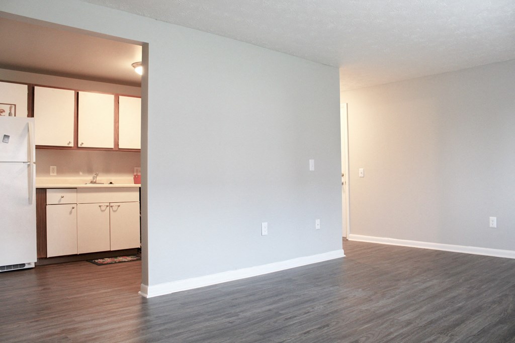 an empty living room with a kitchen in it at Willowbrooke Apartments, Brockport, 14420