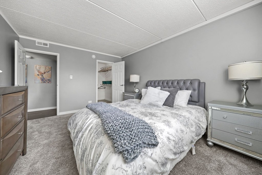 Renovated Bedroom with bed at Woodland Ridge Apartments in Woodridge, IL