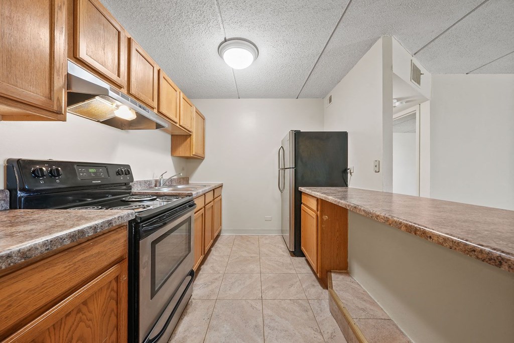 Upgraded Kitchen with wooden counter top at Woodland Ridge Apartments in Woodridge, IL