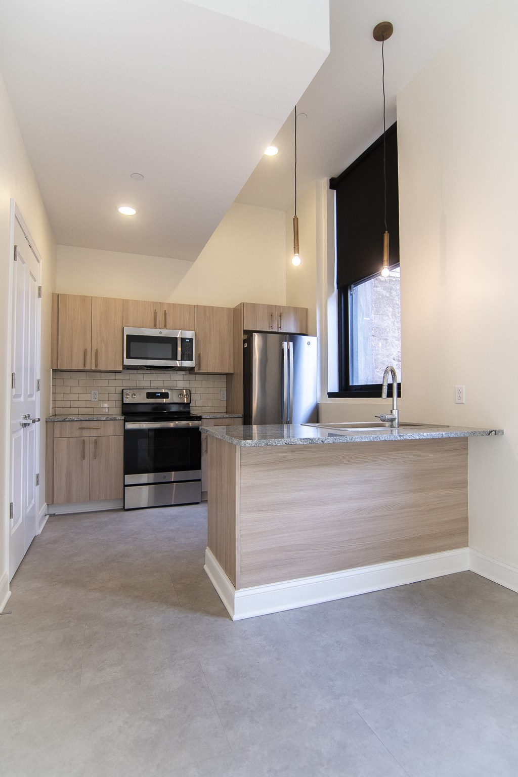 a kitchen with a large island and stainless steel appliances