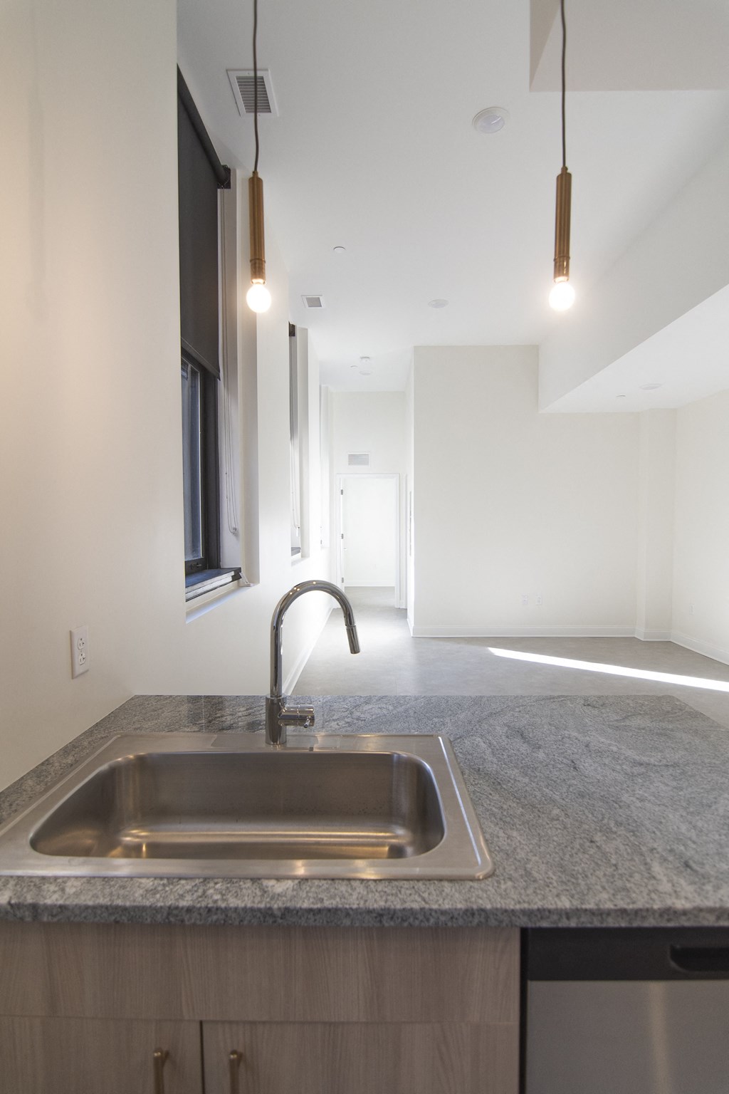 an empty kitchen with a sink and a window