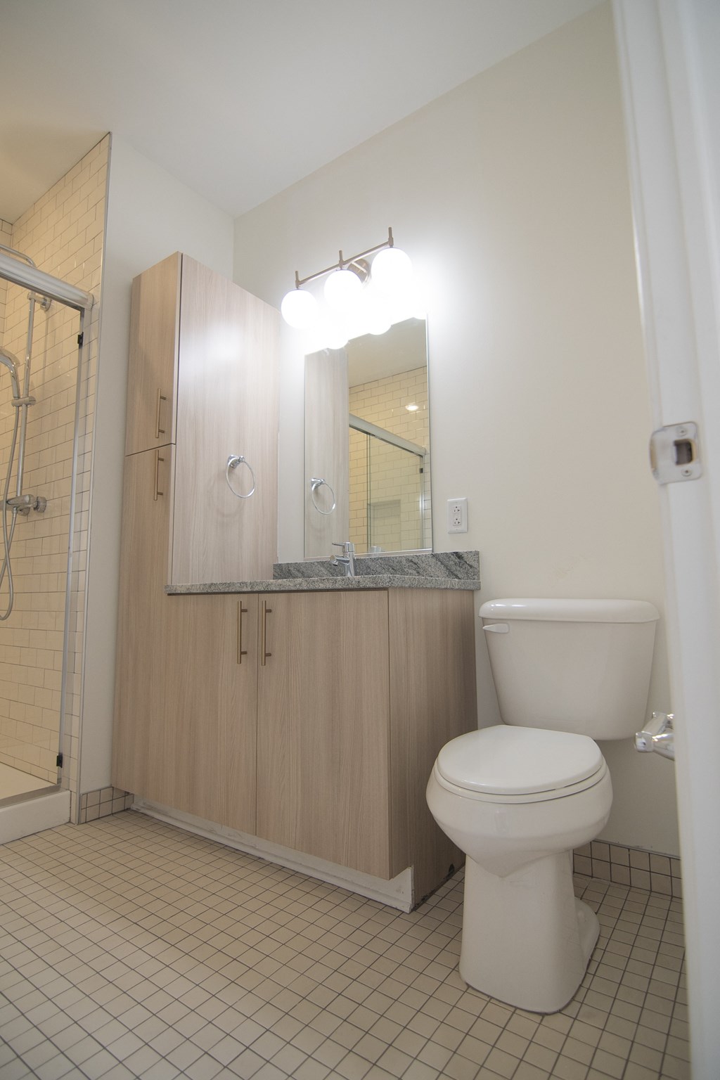 a bathroom with a toilet and a sink and a shower