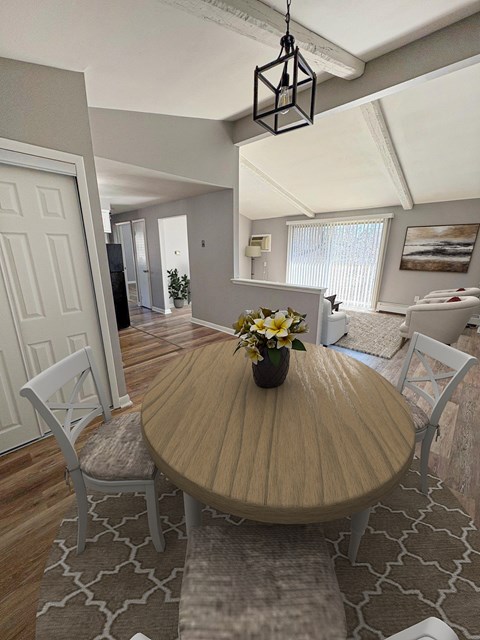 A dining room with a wooden table and chairs.