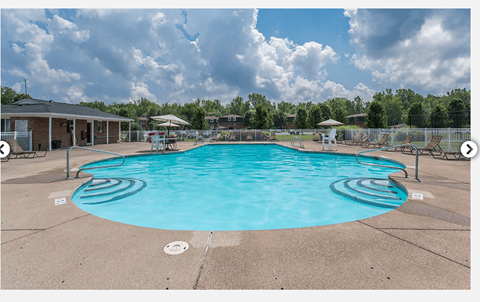 A large swimming pool with a sunny sky above.