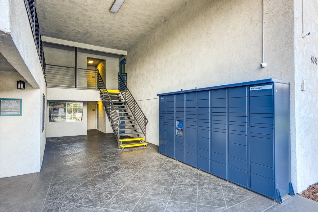 the lockers in the lobby of a building with a staircase