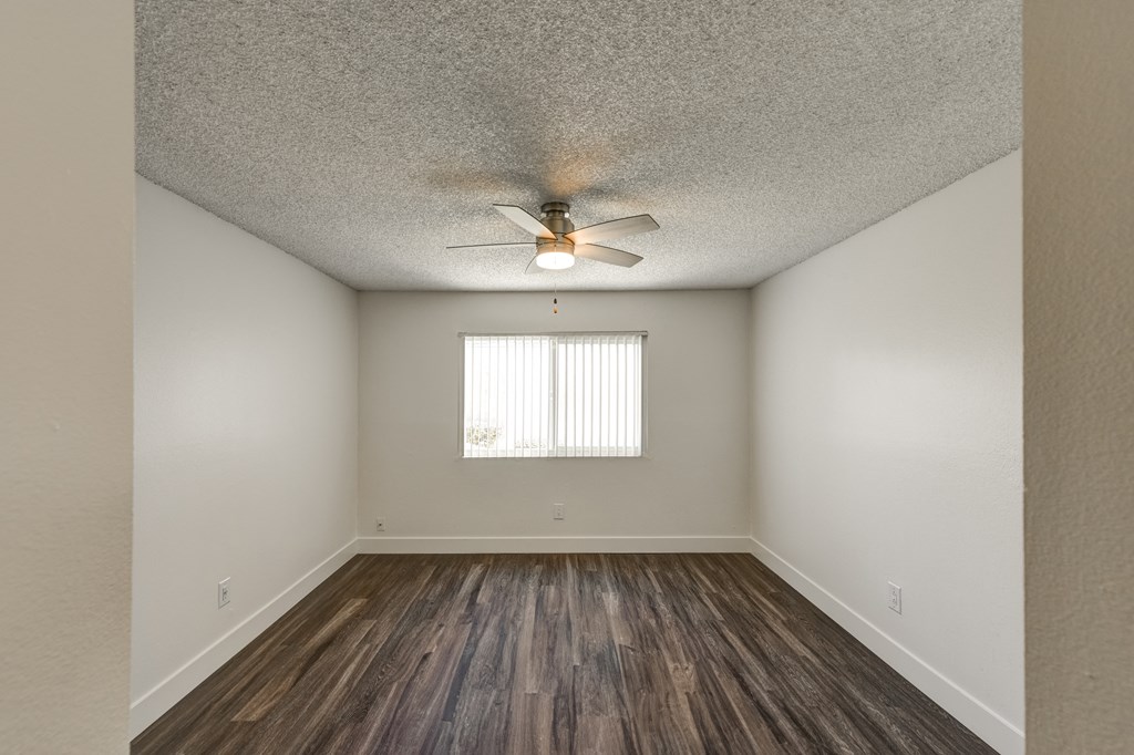 an bedroom with a ceiling fan and a window