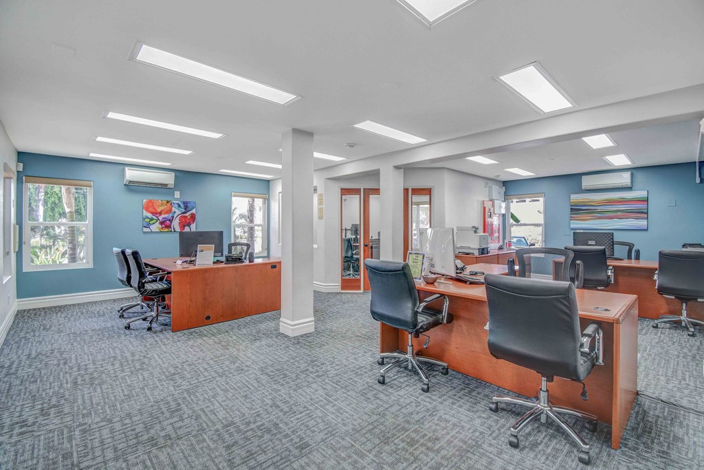 a conference room with desks and chairs