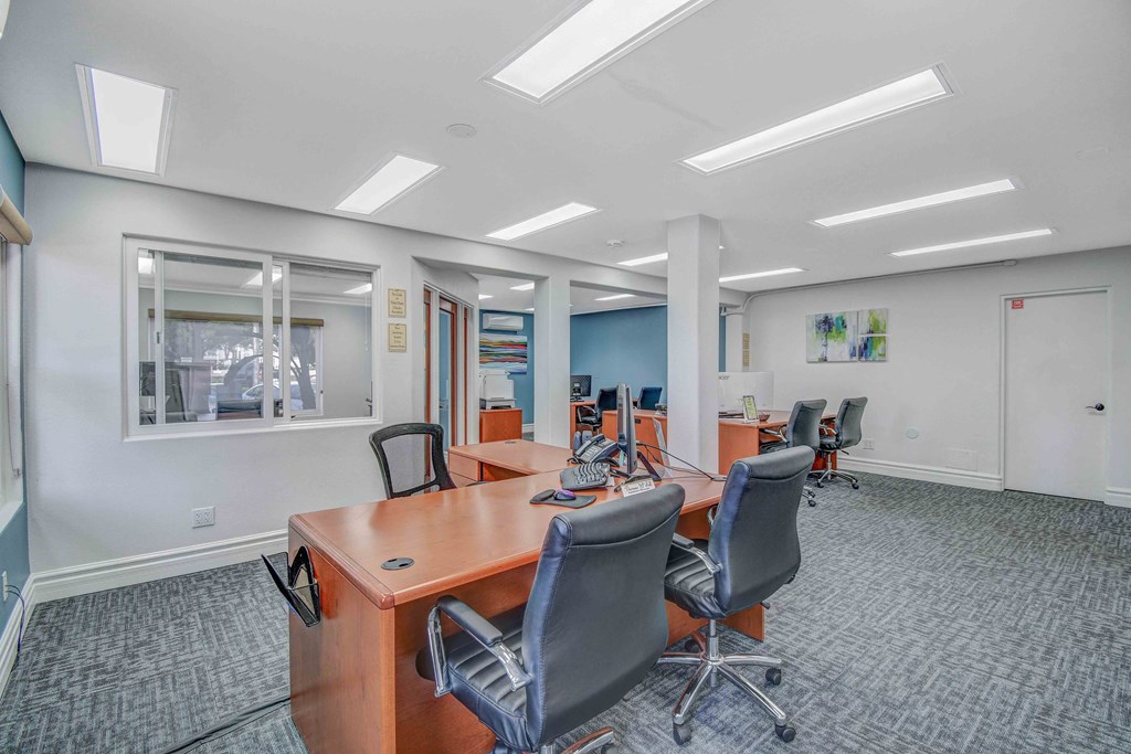 a conference room with desks and chairs