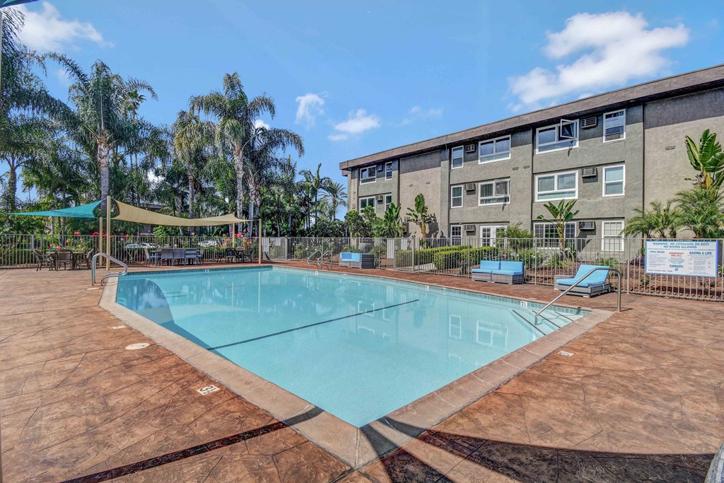 our apartments offer a swimming pool with a building in the background
