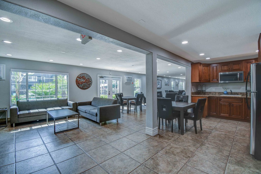 an open living room and kitchen with a table and chairs