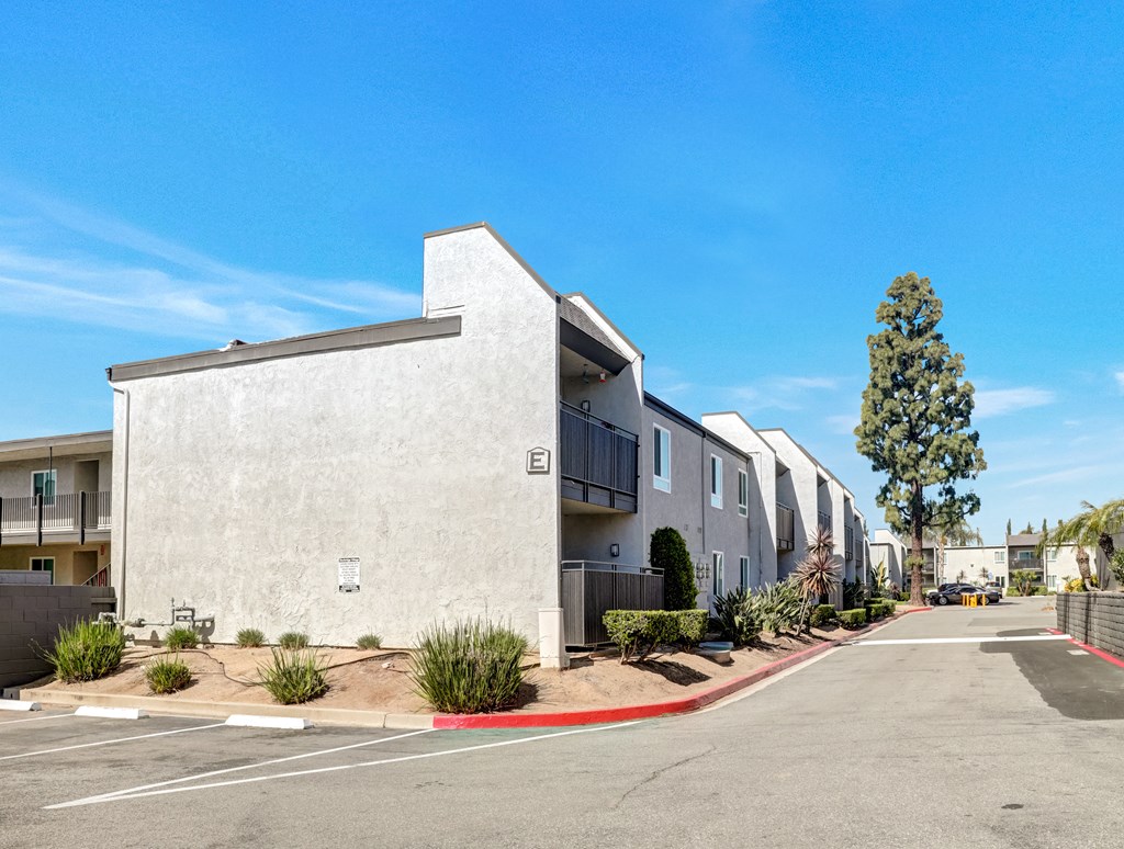 A row of modern apartment buildings with a clear blue sky above.