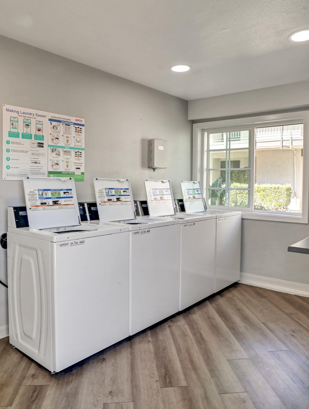 A row of washing machines in a laundromat.