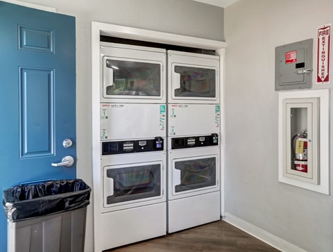 A kitchen with a blue door and a white oven.