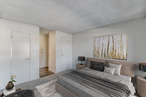 a bedroom with a bed and a painting on the wall
