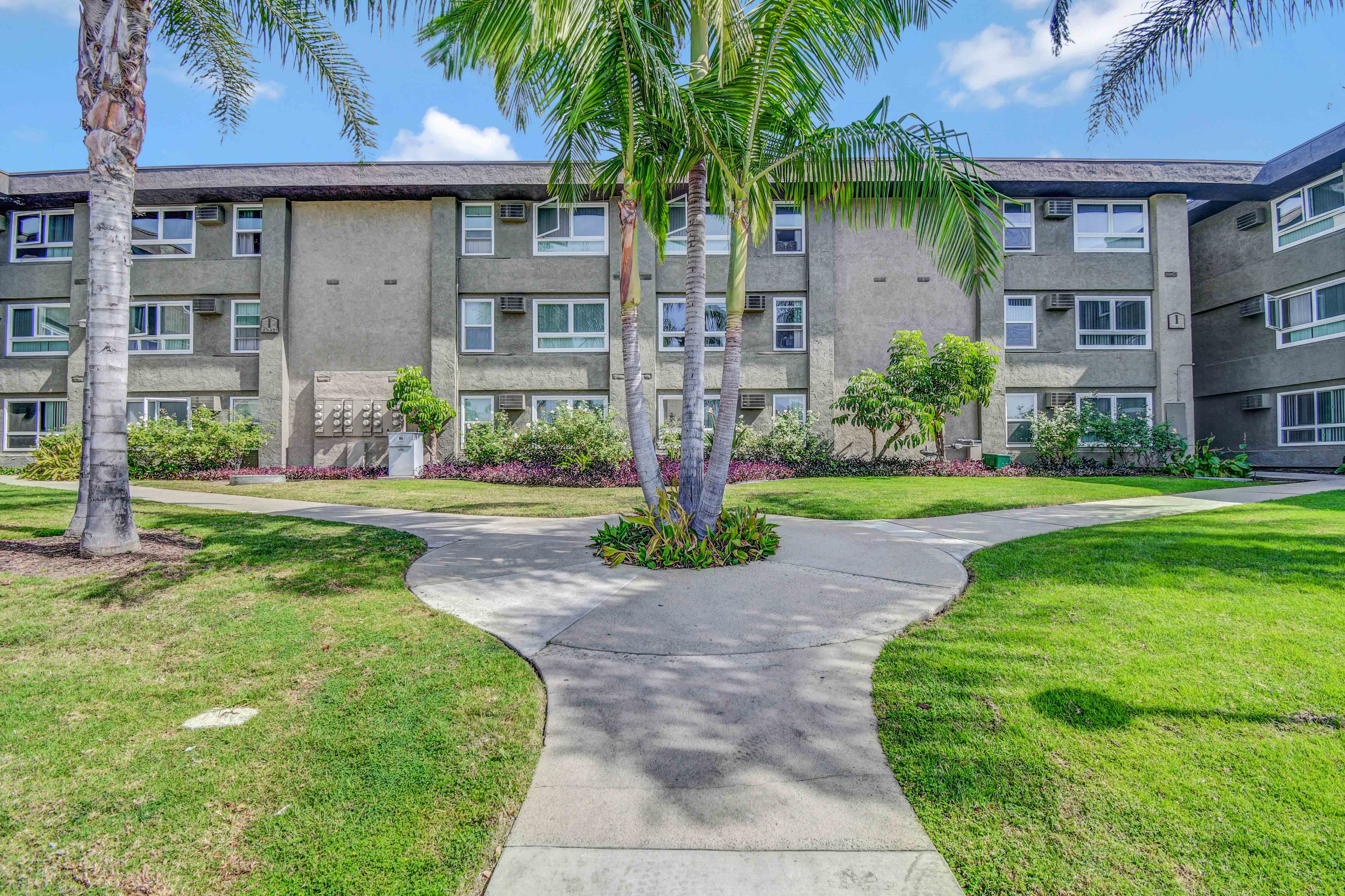 Walkway leading to the G and I building with lush landscaping
