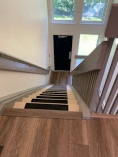 a set of stairs with a black carpeted