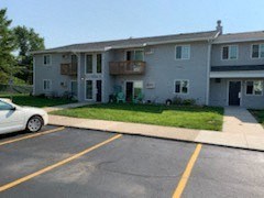 an apartment building with a car parked in front of it