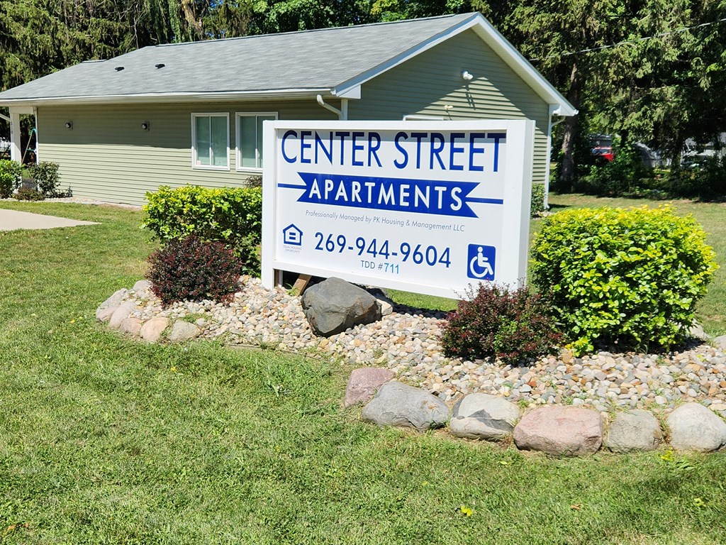 a sign in front of a house that says center street apartments