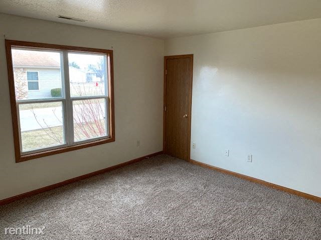 an empty room with a window and a door