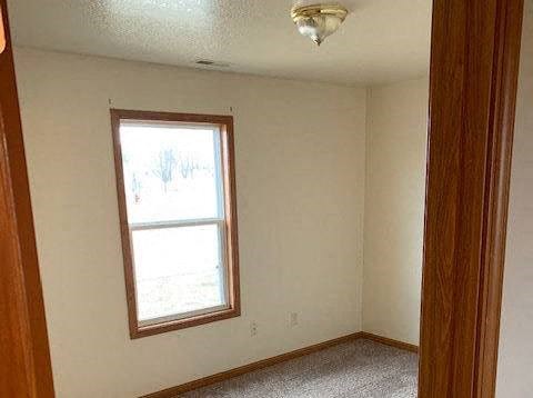 a white room with a window and a wooden door