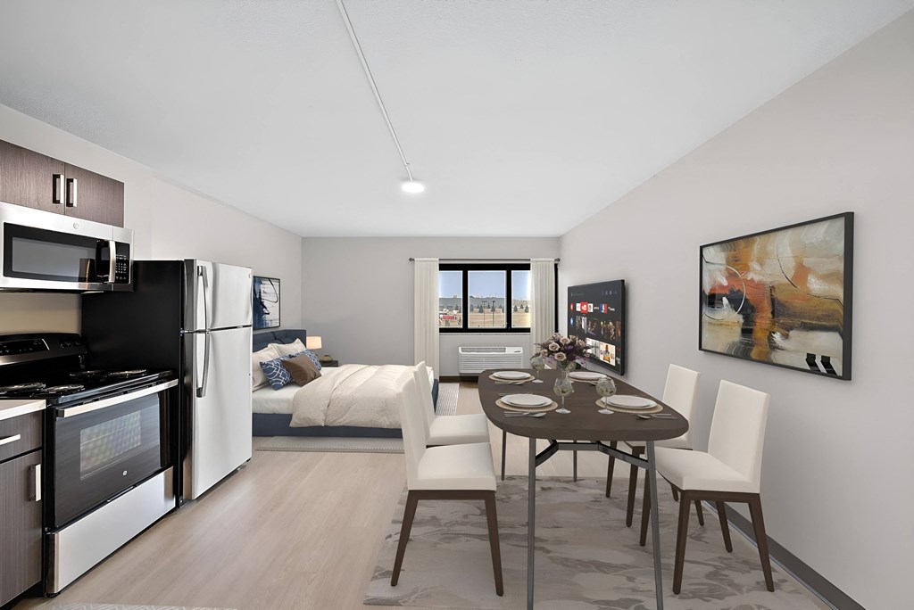 a kitchen and dining room with a table and chairs