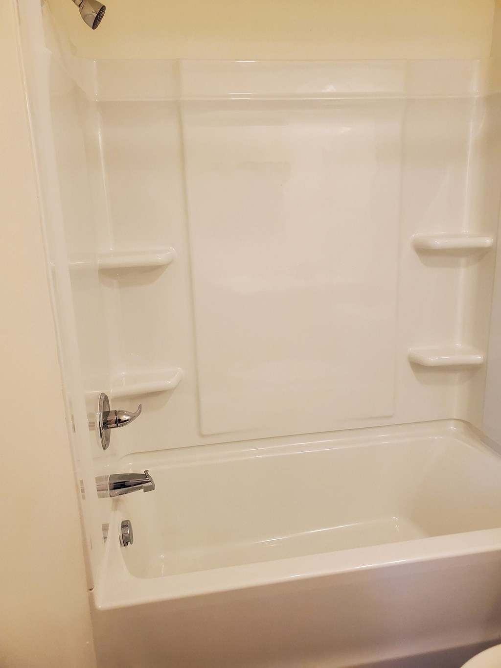 a white bathroom with a shower and a toilet